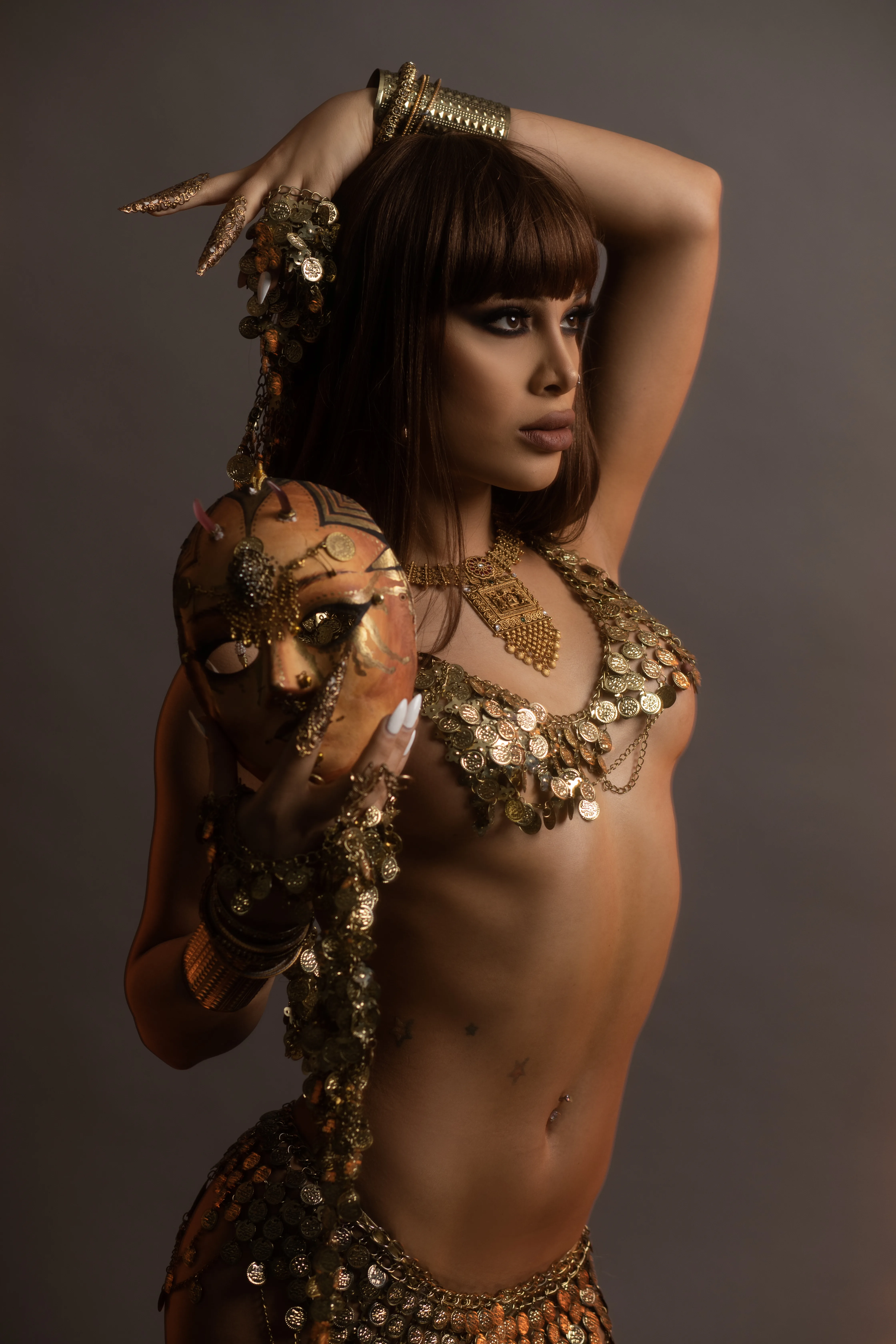 Madam Lola — gold goddess costume, warm dramatic lighting